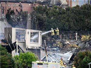 Wildfires destroy 40 homes and kill a firefighter in Australia